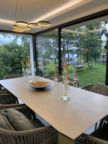 a dining room with a table and some chairs at Luxury Villa with Pool & Sea View-10 Minutes from Monaco in Èze