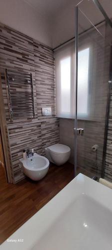 a bathroom with a white tub and a sink at Relax&Business Velletri Centro in Velletri