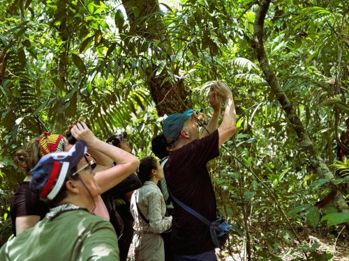 a group of people standing in the forest at Suchipakari Amazon Eco -Lodge & Jungle Reserve in Puerto Misahuallí