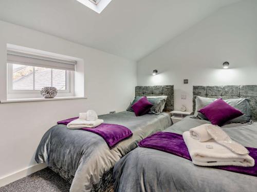 two beds in a room with purple blankets at 3 Bed in Durham 94762 in Lanchester