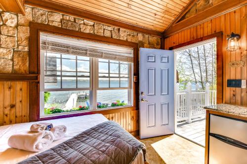 a bedroom with a bed and a window at Waterfront Romulus Getaway with Private Dock! in Romulus