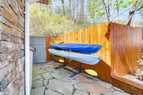 a wooden fence with a boat on a patio at Waterfront Romulus Getaway with Private Dock! in Romulus