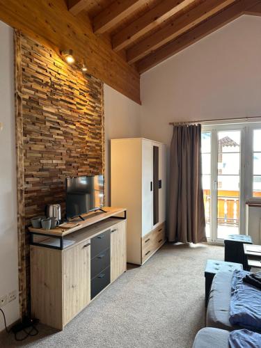 a kitchen with a brick wall and a counter top at Touristenheim Bergfreude in Leukerbad