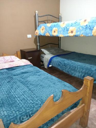 a room with two beds and a bunk bed at Departamento La Plazoleta in San Fernando del Valle de Catamarca