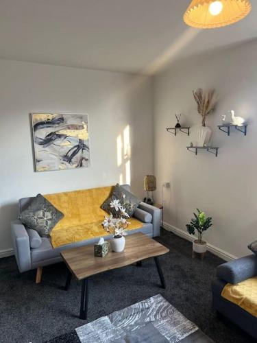 a living room with a couch and a coffee table at Seagulls Apartment in Bridlington