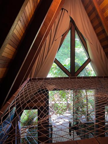 a large window in a room with a roof at Villa Éden in Alter do Chao