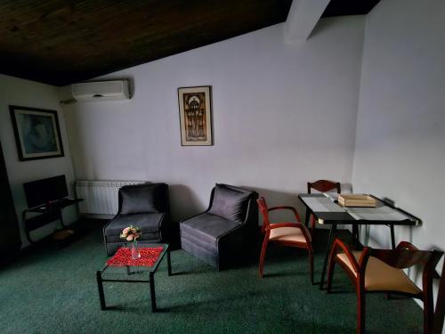 a living room with a table and chairs and a table and chairs at VN APARTMENTS OHRID in Ohrid