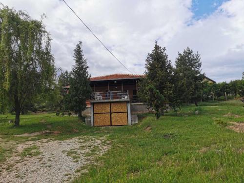 a house in the middle of a field at Cottage House Official in Niš