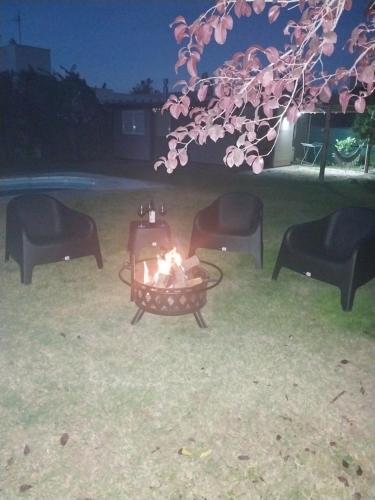 a fire pit in a yard at night at Cabaña Chacras de Caro in Chacras de Coria