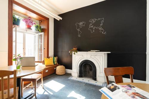 a living room with a fireplace and a black wall at Auberge Internationale de Quebec - HI CANADA in Quebec City