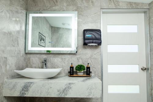 a bathroom with a sink and a mirror at Jazuri Villa in Buccoo