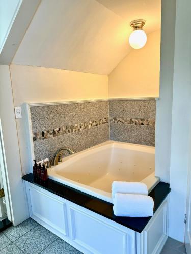 a bathroom with a large tub in a room at Hideaway Inn Maine in Camden