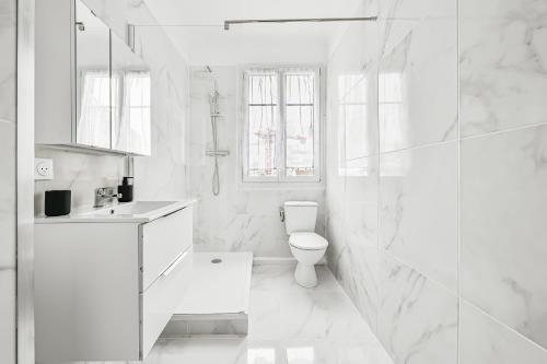 une salle de bain blanche avec toilettes et douche dans l'établissement Skybnb - beau 2 pièces proche Paris - Wifi, à Villejuif