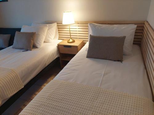 two beds sitting next to each other in a room at Elaion Apartments in Kántanos