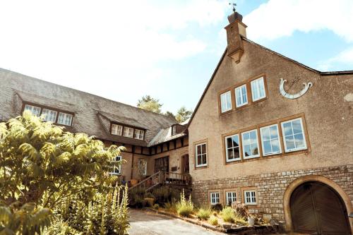 an exterior view of a large brick house at Die Strumpffabrik - Guesthouse in Kerpen