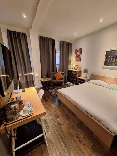 a bedroom with a large bed and a desk and a table at Great room in cool house in York