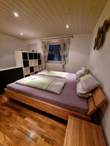 a bedroom with a large bed in a room at Ferienwohnung „Schau ins Frankenland“ in Burgpreppach