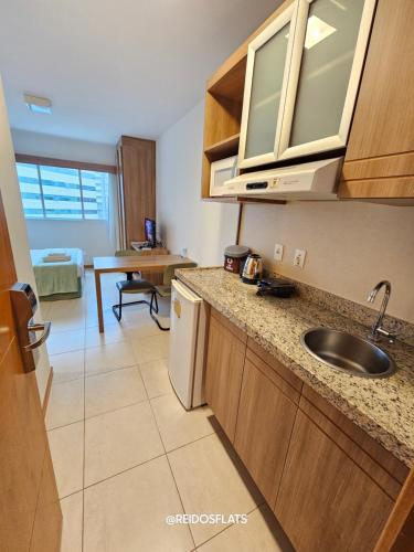 a kitchen with a sink and a counter top at Flat Saint Moritz Express By Rei dos Flats in Brasilia