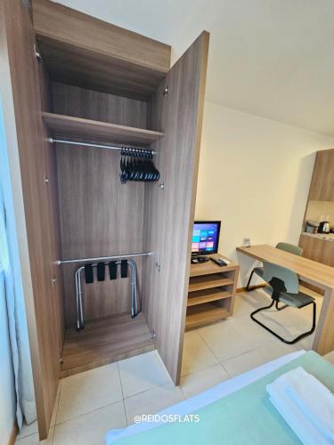 a room with a closet with wine bottles in it at Flat Saint Moritz Express By Rei dos Flats in Brasilia