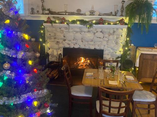 a christmas tree in a dining room with a fireplace at Orcas Hotel in Orcas