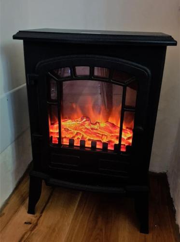 a black stove with a fire inside of it at Charme Apartment St Tome in Almenno San Salvatore
