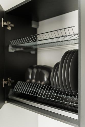 a shelf in an oven with plates and pans at Riverra House in Kaunas