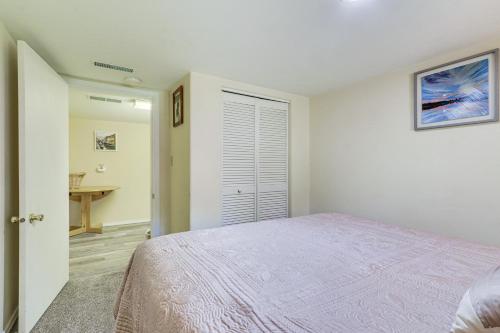 a white bedroom with a bed and a desk at Harrison Home with Grill and Lake Views Walk to Town! in Harrison