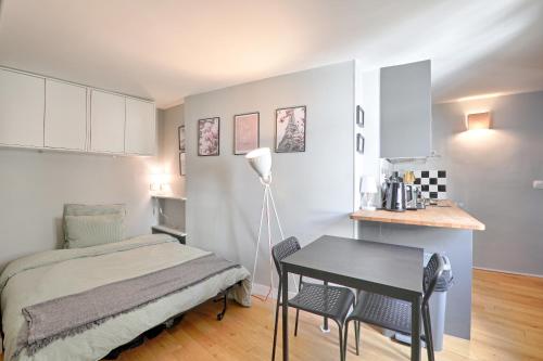 une chambre avec un lit, un bureau et une table dans l'établissement St André 4G - Best Location, à Paris
