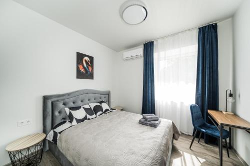 a bedroom with a bed and a desk and a window at Riverra House in Kaunas
