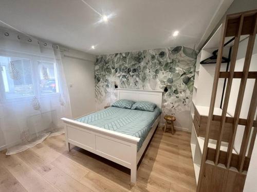 a bedroom with a bed in a room with stairs at chez Corinne in Bray-Dunes