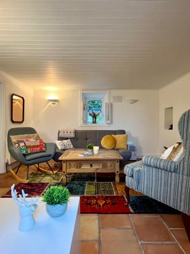 a living room with a couch and a table at Sweet Lamb Farmhouse in New Ross