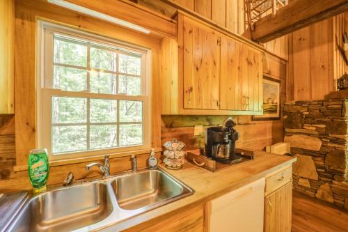a kitchen with a sink and a window at Near Lake Lure Quiet Cabin with Deck and Trail Access in Marion
