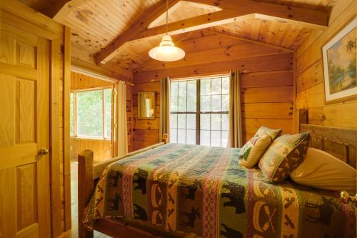 a bedroom with a bed in a wooden cabin at Cataloochee Ski Day Trips! Hot Tub Haven in Marion in Marion