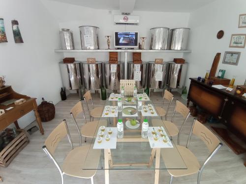 a dining room with tables and chairs and a piano at Kalderimi "Olive Green" House in Promírion