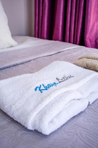 a white towel is sitting on a bed at KhayaLethu Vic Falls 2 in Victoria Falls