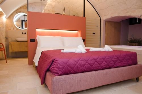 Ένα ή περισσότερα κρεβάτια σε δωμάτιο στο Suite Santa Caterina