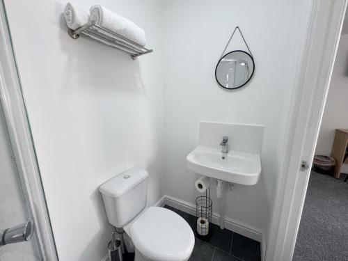 a white bathroom with a toilet and a sink at Relax @ Southfield in Middlesbrough
