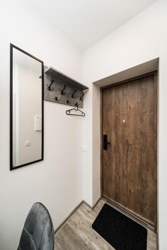 a mirror on the wall next to a door at Riverra House in Kaunas
