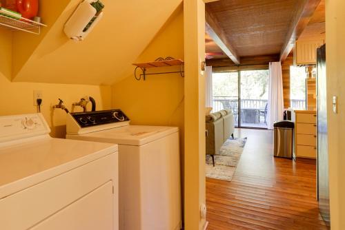 a kitchen with a washer and dryer in a room at Spacious Groveland Cabin with Wraparound Deck! in Groveland