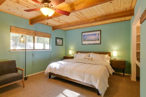 a bedroom with a bed and a ceiling fan at Spacious Groveland Cabin with Wraparound Deck! in Groveland