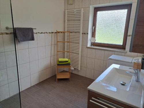 a bathroom with a sink and a shower at Landerhauser-Hof in Schleching
