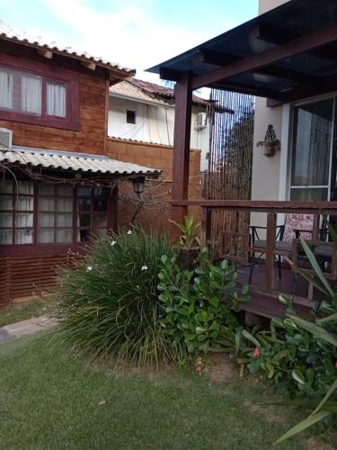 a porch of a house with a wooden deck at Solar Lisboa 100 m da Praia com vista para mar in Balneário Camboriú