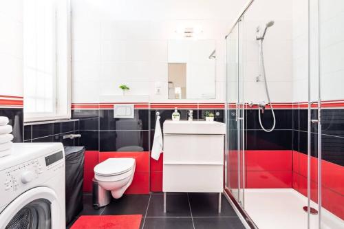 a red and black bathroom with a toilet and a shower at Super central convenient apartment in Budapest