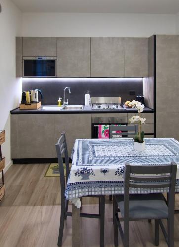 a kitchen with a table with chairs and a sink at Appartamento Casa Del Fabbro in Sovizzo