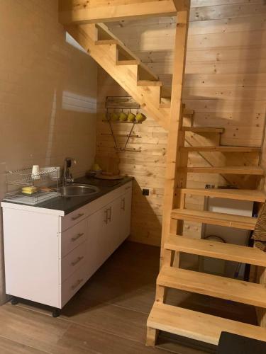 a kitchen with a wooden staircase and a sink at Suncev Brijeg in Banja Luka
