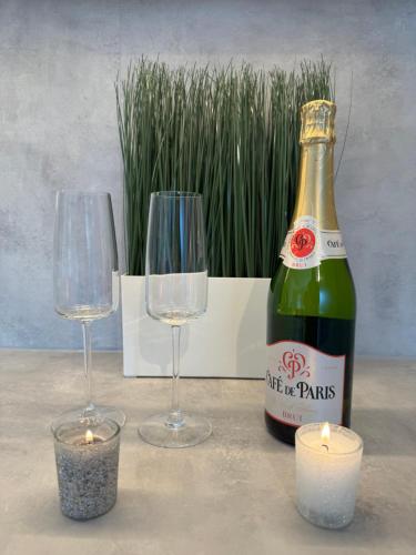 deux verres et une bouteille de champagne et une bougie dans l'établissement Vauban T1 calme avec parking privatif, à Lille