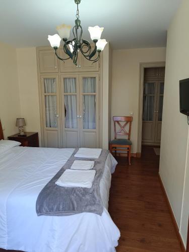 a bedroom with a white bed with towels on it at El espolon in Comillas