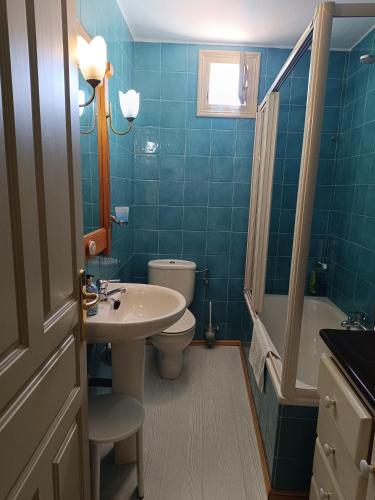 a bathroom with a sink and a toilet and a tub at El espolon in Comillas