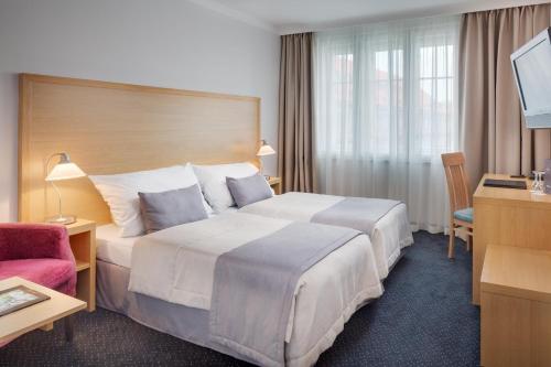 Ein Bett oder Betten in einem Zimmer der Unterkunft New people Hotel & Restaurant