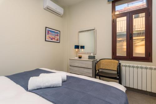 a bedroom with a bed and a mirror and a chair at Bubble Beach 2-BR in Batroun Souks - Parking in Batroûn